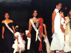 pageant contestants in formal gowns walking across the stage